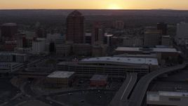5.7K aerial stock footage orbit office tower and shorter hotel tower behind convention center at sunset, Downtown Albuquerque, New Mexico Aerial Stock Footage | DX0002_122_052