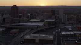 5.7K aerial stock footage flyby office tower and shorter hotel tower behind convention center at sunset, Downtown Albuquerque, New Mexico Aerial Stock Footage | DX0002_122_053