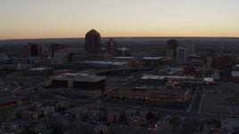 5.7K aerial stock footage of office tower and hotel tower at sunset near office high-rises, Downtown Albuquerque, New Mexico Aerial Stock Footage | DX0002_123_005