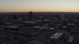 5.7K aerial stock footage reverse view of office tower and hotel tower at sunset near office high-rises, Downtown Albuquerque, New Mexico Aerial Stock Footage | DX0002_123_006