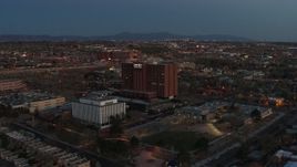 5.7K aerial stock footage fly toward and orbit a hospital at twilight in Albuquerque, New Mexico Aerial Stock Footage | DX0002_123_019