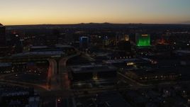 5.7K aerial stock footage of the DoubleTree hotel with blue lighting near office buildings at twilight, Downtown Albuquerque, New Mexico Aerial Stock Footage | DX0002_123_029