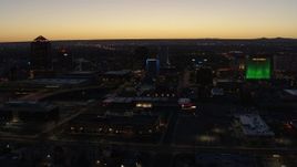 5.7K aerial stock footage of passing DoubleTree hotel with blue lighting near office buildings at twilight, Downtown Albuquerque, New Mexico Aerial Stock Footage | DX0002_123_030