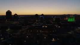 5.7K aerial stock footage descend past hotel with blue lighting near office towers at twilight, Downtown Albuquerque, New Mexico Aerial Stock Footage | DX0002_123_034