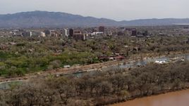 5.7K aerial stock footage approach high-rise office buildings while ascending over the Rio Grande and park, Downtown Albuquerque, New Mexico Aerial Stock Footage | DX0002_124_005