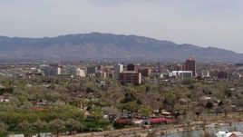 5.7K aerial stock footage descend with wide view of high-rise office buildings, distant mountains, Downtown Albuquerque, New Mexico Aerial Stock Footage | DX0002_124_018
