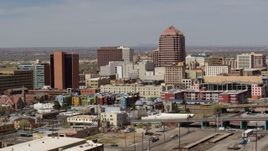 5.7K aerial stock footage of an office high-rise towering over city buildings, Downtown Albuquerque, New Mexico Aerial Stock Footage | DX0002_124_022