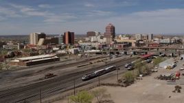 5.7K aerial stock footage flyby railroad tracks with view of Albuquerque Plaza office high-rise, Downtown Albuquerque, New Mexico Aerial Stock Footage | DX0002_124_028