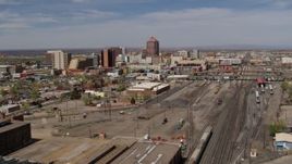 5.7K aerial stock footage flyby train tracks with office buildings in the background, Downtown Albuquerque, New Mexico Aerial Stock Footage | DX0002_124_032