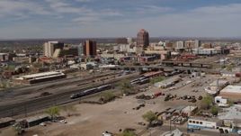 5.7K aerial stock footage approach train tracks with office buildings in the background, Downtown Albuquerque, New Mexico Aerial Stock Footage | DX0002_124_033