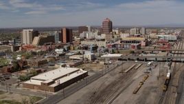 5.7K aerial stock footage reverse view of train tracks and office buildings in the background, Downtown Albuquerque, New Mexico Aerial Stock Footage | DX0002_124_034