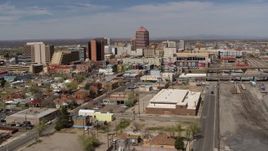 5.7K aerial stock footage reverse view of office buildings, and flyby railroad tracks, Downtown Albuquerque, New Mexico Aerial Stock Footage | DX0002_124_036