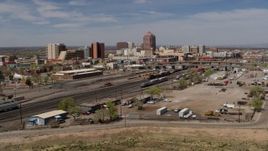 5.7K aerial stock footage descend and fly away from train tracks with office buildings in the distance, Downtown Albuquerque, New Mexico Aerial Stock Footage | DX0002_124_037