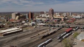 5.7K aerial stock footage approach train tracks and office buildings in the distance, Downtown Albuquerque, New Mexico Aerial Stock Footage | DX0002_124_038