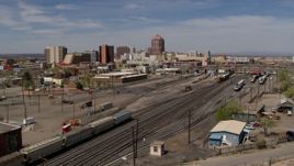 5.7K aerial stock footage of distant office buildings seen from railroad tracks, Downtown Albuquerque, New Mexico Aerial Stock Footage | DX0002_124_040