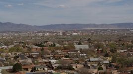 5.7K aerial stock footage passing by suburban homes with a view of Downtown Albuquerque in the background, New Mexico Aerial Stock Footage | DX0002_126_002