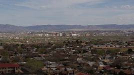5.7K aerial stock footage ascend past suburban homes with a view of Downtown Albuquerque in the distance, New Mexico Aerial Stock Footage | DX0002_126_004