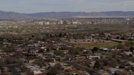 5.7K aerial stock footage flying by a suburban neighborhood with a view of Downtown Albuquerque in the distance, New Mexico Aerial Stock Footage | DX0002_126_005