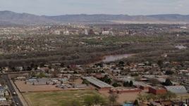 5.7K aerial stock footage ascend over suburban neighborhood with Downtown Albuquerque beyond Rio Grande, New Mexico Aerial Stock Footage | DX0002_126_008
