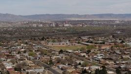 5.7K aerial stock footage fly away from Downtown Albuquerque and Rio Grande, seen from suburban homes, New Mexico Aerial Stock Footage | DX0002_126_010