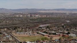 5.7K aerial stock footage of Downtown Albuquerque and Rio Grande, seen while ascending from suburban homes, New Mexico Aerial Stock Footage | DX0002_126_012