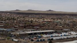 5.7K aerial stock footage of suburban neighborhood across freeway, descend near warehouse building in Albuquerque, New Mexico Aerial Stock Footage | DX0002_126_015
