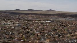 5.7K aerial stock footage of descend past suburban neighborhood, reveal freeway, Albuquerque, New Mexico Aerial Stock Footage | DX0002_126_018