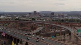5.7K aerial stock footage of Downtown Albuquerque seen while flying by freeway interchange, New Mexico Aerial Stock Footage | DX0002_126_021
