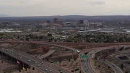 5.7K aerial stock footage of Downtown Albuquerque seen while ascending near freeway interchange traffic, New Mexico Aerial Stock Footage | DX0002_126_024