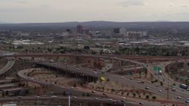 5.7K aerial stock footage of Downtown Albuquerque seen while descending near freeway interchange traffic, New Mexico Aerial Stock Footage | DX0002_126_026