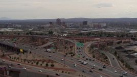 5.7K aerial stock footage of Downtown Albuquerque buildings seen from freeway interchange traffic, New Mexico Aerial Stock Footage | DX0002_126_027
