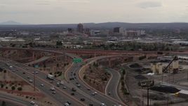 5.7K aerial stock footage of Downtown Albuquerque buildings seen while descending by freeway interchange traffic, New Mexico Aerial Stock Footage | DX0002_126_031