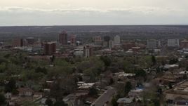 5.7K aerial stock footage of ascending from residential street to focus on Downtown Albuquerque, New Mexico Aerial Stock Footage | DX0002_126_035