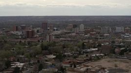 5.7K aerial stock footage reverse view of city's high-rise buildings seen from neighborhood, Downtown Albuquerque, New Mexico Aerial Stock Footage | DX0002_126_037