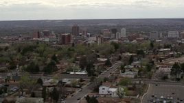 5.7K aerial stock footage wide view of city's high-rises seen while flying by homes, Downtown Albuquerque, New Mexico Aerial Stock Footage | DX0002_126_043