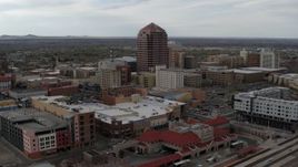 5.7K aerial stock footage flying away from Albuquerque Plaza high-rise and neighboring city buildings, Downtown Albuquerque, New Mexico Aerial Stock Footage | DX0002_127_006