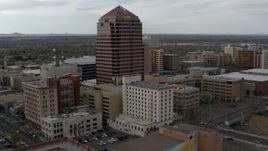 5.7K aerial stock footage orbit and fly away from Albuquerque Plaza and neighboring city buildings, Downtown Albuquerque, New Mexico Aerial Stock Footage | DX0002_127_011