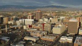 5.7K aerial stock footage of flying by Albuquerque Plaza towering over city buildings, Downtown Albuquerque, New Mexico Aerial Stock Footage | DX0002_127_028