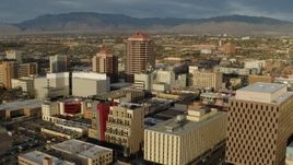 5.7K aerial stock footage orbit and fly away from Albuquerque Plaza high-rise towering over city buildings, Downtown Albuquerque, New Mexico Aerial Stock Footage | DX0002_127_032