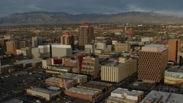 5.7K aerial stock footage wide orbit of office high-rise and city buildings and descend, Downtown Albuquerque, New Mexico Aerial Stock Footage | DX0002_127_040