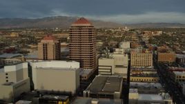 5.7K aerial stock footage approach and then orbit office high-rise at the center of city buildings, Downtown Albuquerque, New Mexico Aerial Stock Footage | DX0002_127_042