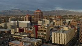 5.7K aerial stock footage circling office high-rise at the center of city buildings, Downtown Albuquerque, New Mexico Aerial Stock Footage | DX0002_127_044