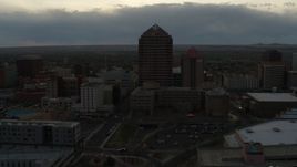 5.7K aerial stock footage of a reverse view of office high-rise and hotel at sunset, Downtown Albuquerque, New Mexico Aerial Stock Footage | DX0002_128_002
