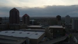 5.7K aerial stock footage reverse view of office tower, hotel, Kiva Auditorium, convention center at sunset, Downtown Albuquerque, New Mexico Aerial Stock Footage | DX0002_128_010