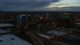 5.7K aerial stock footage orbit and fly away from hotel and office buildings at twilight, Downtown Albuquerque, New Mexico Aerial Stock Footage | DX0002_128_021