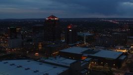 5.7K aerial stock footage ascend with view of office high-rise, hotel and Kiva Auditorium at twilight, Downtown Albuquerque, New Mexico Aerial Stock Footage | DX0002_128_027