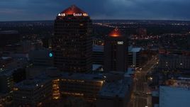5.7K aerial stock footage orbit and fly away from office high-rise and hotel at twilight, Downtown Albuquerque, New Mexico Aerial Stock Footage | DX0002_128_031