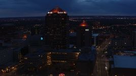 5.7K aerial stock footage fly toward and circle office high-rise beside hotel at twilight, Downtown Albuquerque, New Mexico Aerial Stock Footage | DX0002_128_035