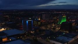 5.7K aerial stock footage fly away from hotel and office buildings at twilight, Downtown Albuquerque, New Mexico Aerial Stock Footage | DX0002_128_036