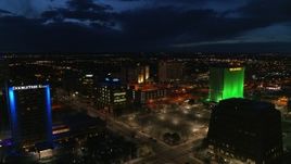 5.7K aerial stock footage orbit and fly away from office buildings at twilight, reveal hotel, Downtown Albuquerque, New Mexico Aerial Stock Footage | DX0002_128_043